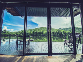 Scenic view of swimming pool against sky seen through window