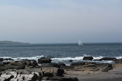 Sailboat in the horizon off the irish coast