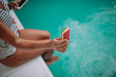 Midsection of woman holding ice cream