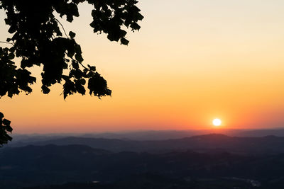 Scenic view of silhouette landscape against romantic sky at sunset