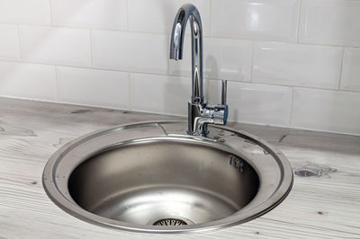 Close-up of faucet with sink at home