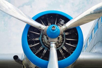 Close-up of airplane propeller against blue sky