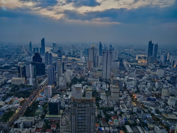 Aerial view of buildings in city against sky