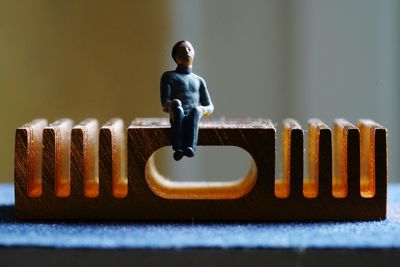 Close-up of figurine on wood