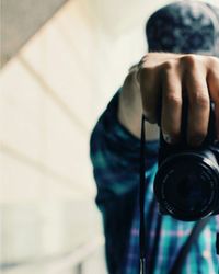 Cropped image of man holding digital camera