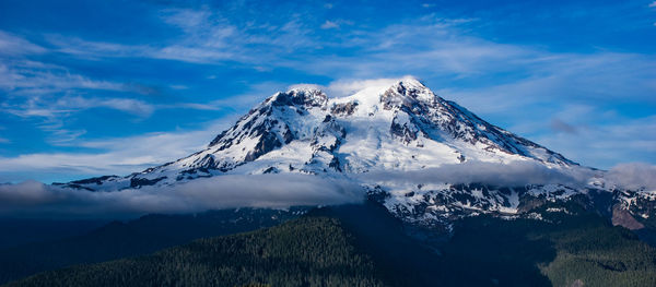 Scenic view of snowcapped mountains against sky