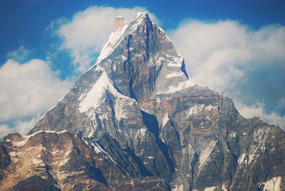 Low angle view of annapurna machapuchare mountain against sky