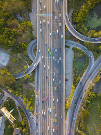 Vehicles on road against bridge in city