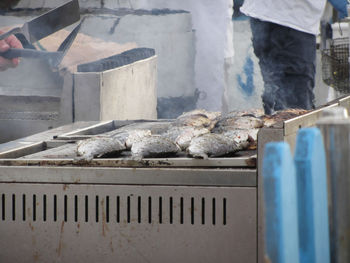 Low section of man standing on fish