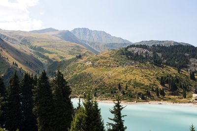 Scenic view of lake and mountains against sky