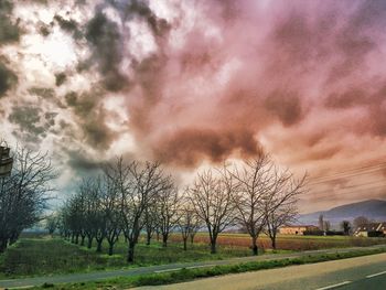 Scenic view of field against cloudy sky