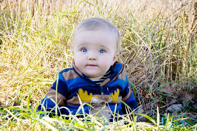 Portrait of cute boy on grassy field