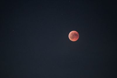 Low angle view of moon against sky at night