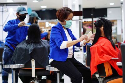 Rear view of people standing in corridor