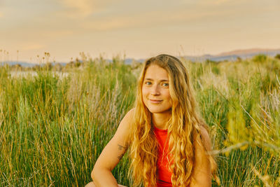 Portrait of smiling young woman on field