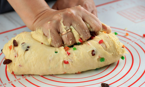 Cropped hand of person preparing food