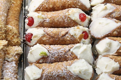 Background of stuffed pastries called cannoli siciliani in italian language 
