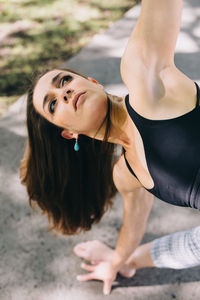 High angle portrait of woman with arms raised