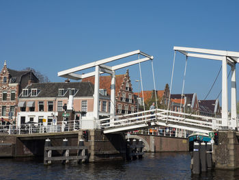 View of bridge over river against buildings