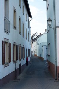 Road amidst buildings against sky