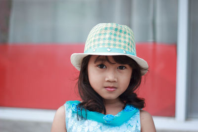 Portrait of cute girl wearing hat while standing outdoors