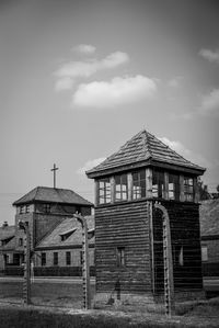 Old house on field against sky