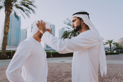 Side view of businessmen standing outdoors