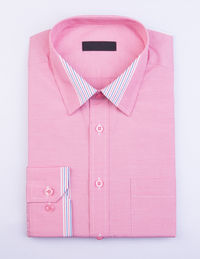 Close-up of pink shirt on white background