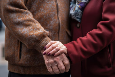 Midsection of man holding hands