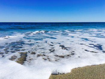 View of calm blue sea against clear sky