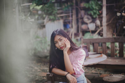 Portrait of young woman standing outdoors