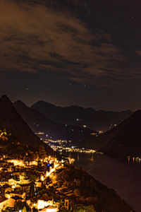 High angle view of illuminated buildings against sky at night