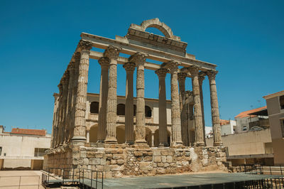 Low angle view of historical building against clear blue sky