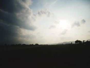 Scenic view of silhouette field against sky