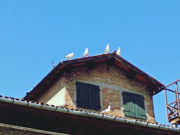 Low angle view of built structure against blue sky