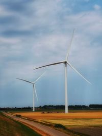 Windmill on field against sky