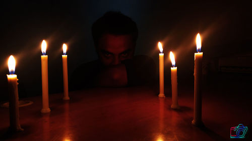 Close-up of illuminated candles on table