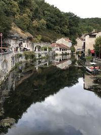 Reflection of buildings and trees in lake