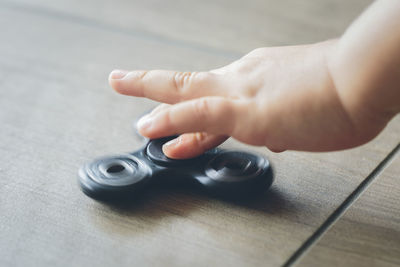 Close-up of baby using fidget spinner