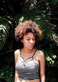 Young woman with palm tree