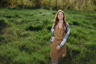 Young woman standing on field