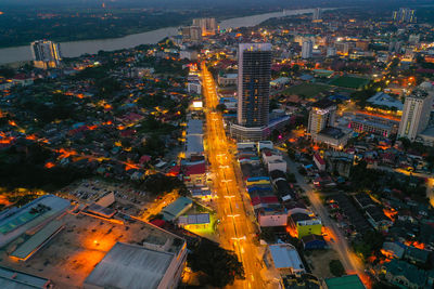 High angle view of illuminated street amidst buildings in city