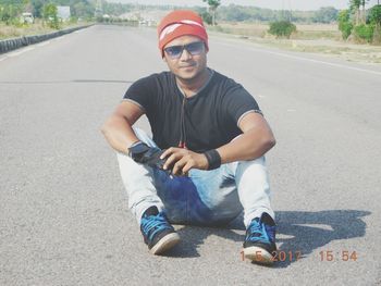 Portrait of young man on road