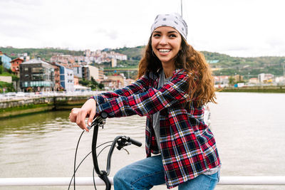 Portrait of smiling young woman in city