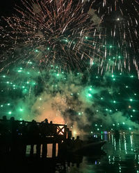 Low angle view of firework display at night