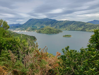 Scenic view of lake and mountains against sky