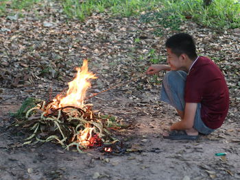 Boy with fire in the ground