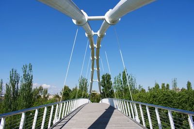 Footbridge against clear blue sky