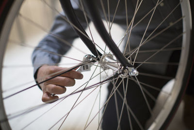 Cropped image of man repairing bicycle