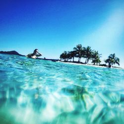 Swimming pool in sea against clear blue sky